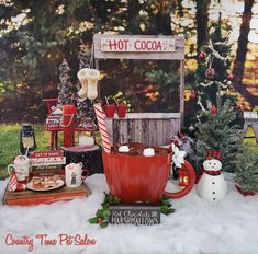 a hot chocolate stand with christmas decorations and snowmen