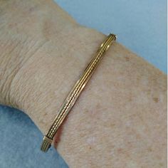 A pretty little bracelet of four strands of 14kt gold filled wire--two twist in the middle and two plain square on either side. So sweet and feminine! This one stacks nicely with a number of my other bangle-style bracelets! The sturdy built-in hook and eye clasp is easy to get on and off by yourself. Choose your size for a perfect custom fit! This design is also available in sterling silver and two-tone. Add on a jewelry polishing cloth to keep your bracelet--and ALL your jewelry--shiny clean! h Classic Friendship Bangle Bracelets, Classic Bangle Bracelets For Friendship, Dainty Gold Bracelet, Adjustable And Flexible, Dainty Gold Bracelet Adjustable And Flexible, Elegant Gold Hand Wrapped Stretch Bracelet, Elegant Jubilee Cuff Bracelet For Friendship, Classic Adjustable Braided Bangle Bracelet, Elegant Friendship Wrap Bracelet, Dainty Adjustable Cuff Bracelet With Jubilee Style