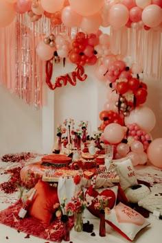 the table is set up with balloons and confetti