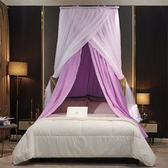 a bed with a purple canopy over it