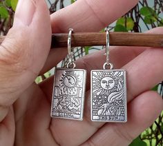 Beautifully detailed Tarot Cards dangle from silver plate Lever Back Ear Wires. The Sun and La Luna are depicted on a pair of double sided silver tarot cards. One of my very favorite designs, these fortune teller earrings are both elegant and edgy, a perfect combination and the ideal gift for mystical folks on you list.  Your Tarot Card Earrings will arrive in an organza pouch with a matching polishing cloth.  Use code 3GETS20 to receive a 20% discount every time you order 3 or more items from A Tarot Card Earrings, Tarot Earrings, Card Earrings, Earrings Goth, Earrings Ideas, Dragon Earrings, Organza Pouch, Carnelian Beads, Fortune Teller