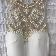 Nwt. Ivory Floor Length Gown With Gorgeous Ivory & Gold Beading And Rhinestone Detailing Over Mesh On Top/Chest Part Of Dress. High Neck. Back Detailing Is So Gorgeous. Bottom Of Dress Trails A Little. Lined. Size 2. Comes With Small Bag Of Extra Beads. Purchased This Lovely Dress For My Wedding And Ended Up Wearing Another. Few Spots (9ish) Where Rhinestones Have Fallen Off. They Appear As Black Spots In Photos. Easily Repaired. White Sequined Evening Dress For Gala, Fitted White Evening Dress With Sequins, Fitted White Sequin Evening Dress, White Fitted Evening Dress With Sequins, White Fitted Sequin Evening Dress, White Embellished Evening Dress For Gala, Beaded Evening Dress With Fitted Bodice For Prom, White Sequined Sleeveless Evening Dress, White Sleeveless Sequin Evening Dress