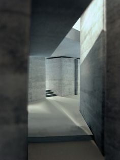 an empty room with concrete walls and stairs