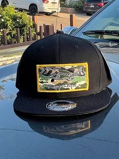 embroidered camo patch on a snapback flatbill black hat with gold merrow. Snapback Hats With Patches For Streetwear, Streetwear Snapback Hat With Patches, Black Snapback Hat With Embroidered Patch, Black Snapback Hat With Embroidered Patch For Outdoor, Outdoor Black Snapback Hat With Embroidered Patch, Black Snapback Hat With Patches, Black Snapback Hat With Embroidered Patch For Streetwear, Snapback Hat With Embroidered Patch, Streetwear Snapback Hat With Embroidered Patch