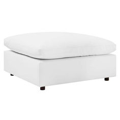 a white footstool sitting on top of a bed