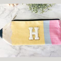 Get this cute custom letter pencil pouch for teacher appreciation gift. This is the perfect teacher accessory bag. Want to make it a gift box? Click on the link below for the gift box listing: https://wild4style.etsy.com/listing/1725430682 Include more teacher items with the pouch. Click on our bestsellers in teacher accessories below to add to your order. 🍎 Cute Teacher Studs: https://wild4style.etsy.com/listing/1515701279 📝 Notepad & Pen: https://wild4style.etsy.com/listing/1700480148 ✏ Penc Yellow Zipper Pouch Pencil Case, Yellow Zipper Pencil Case, Back To School Bag With Pen Holders For Gift, Back To School Bag With Pen Holders, Multicolor Craft Supplies For Teacher Appreciation, Back To School, Back To School Zipper Pouch Stationery For Personal Use, Educational Stationery For End Of School Year, End Of School Year Zipper Pouch Pencil Case, Cute Customizable Craft Supplies For School