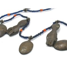 Naga Ancestor Necklace with 19th Century Bronze Heads and Figures Framing this magnificent Naga Ancestor/ "Head Hunter's" Bronze Charm Collection are Hand-wound Naga Heirloom Glass Beads, originally created in the late 19th century up until the mid 20th century in China, and made to resemble precious red coral, turquoise, lapis lazuli and golden amber. These richly colored beads were later traded among Naga people in Northern India and Burma. Because of their rarity and desirability, these "fore Antique Beaded Pendant Necklace, Antique Beaded Pendant Jewelry, Ceremonial Beaded Pendant Jewelry, Vintage Ceremonial Jewelry With Polished Beads, Artisan Hand-strung Jewelry For Ceremonial Occasions, Head Hunter, Hand Wound, Brass Pendants, Golden Amber