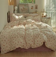 a bedroom with a bed covered in pink and white sheets