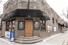 an old brick building with posters on the front