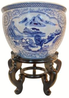 a large blue and white bowl sitting on top of a stand