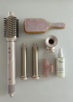 an assortment of hair care items including a brush, blow dryer, and lotion