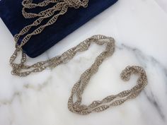 "A wonderful vintage long chain necklace with twisted wire links in silver tone metal. It is a Mexican wedding necklace, which would be worn around both the bride and groom while they saw their vows. No marks. Measures about 71\" long. Lots of tarnish and wear, I have not tried to clean or polish. Actual packaging will vary depending on item/s purchased and tape pattern available. Props shown in photos is for display purposes only, not included in this listing. As always, satisfaction is guarant Silver Double Chain Necklace For Wedding, Silver Rope Chain Necklace For Formal Occasions, Formal Silver Rope Chain Necklace, Elegant Silver Chain Necklace For Wedding, Silver Chain Link Jewelry For Wedding, Silver Long Chain Necklace For Evening, Wedding Chain Link Necklace, Silver Long Necklace For Evening, Silver Necklace With Chain Strap For Evening