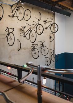 there are many bikes on the wall in this room