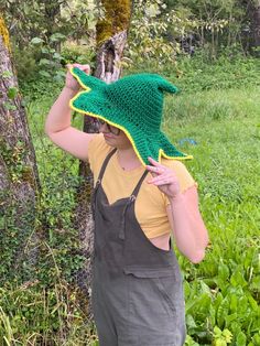 A person is wearing a crocheted green, slouchy witch hat with a star shaped brim. The brim is gold. They have their head tilted down and hands  holding the brim to show the hat off Crochet Star Hat, Witch Hat Pattern, Star Witch, Loom Crochet, Big Twist, Crochet Tips, Crochet Stars, Floral Wire, Witch Hat