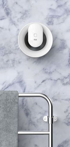 a close up of a white plate on a marble counter top with a towel rack