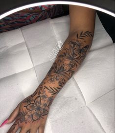 a woman's arm with flowers on it