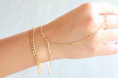 Double gold chain bracelet with attached gold ring Minimalist Gold-tone Chunky Chain Bracelet, Elegant Gold Plated Chain Link Chain Ring, Elegant Gold Plated Chain Link Ring, Elegant Gold Oval Link Chain Ring, Gold Metal Chain Bracelet With Adjustable Chain, Gold Plated Chain Link Ring, Chic Jewelry With Chain Strap For Gift, Adjustable Gold-plated Chain Charm Bracelet, Adjustable Gold-tone Charm Bracelet With Gold Chain