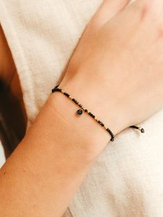 This bracelet of tiny black spinel beads and gold details is decorated with a small black spinel charm. It is a minimalist, simple and elegant bracelet, perfect for any summer event or for everyday wear. Also, it could be perfect as a birthstone gift for August.  It is a fully adjustable bracelet thanks to its good quality nylon cord.  ** M A T C H I N G   C H O K E R ** Don't forget to visit the matching choker in our store! https://www.etsy.com/es/listing/1134766149/elegant-black-necklace-with-gemstone ** D E T A I L S ** Gemstones size we use are black spinel 2mm and black spinel charm 4mm.  Materials: AAA spinel beads, gold filled and good quality nylon.  Our bracelets are adjustable with knots so that you can put them to the measure that you like the most. Gemstones we use in our brac Minimalist Black Bracelet, Minimalist Black Bracelets For Everyday, Black Minimalist Bracelets For Everyday Wear, Minimalist Black Beads Bracelet As Gift, Minimalist Black Beads Bracelets As Gift, Minimalist Black Bead Bracelets As Gift, Minimalist Black Beads Bracelet For Gift, Dainty Black Beaded Bracelets For Gift, Minimalist Black Beaded Bracelets