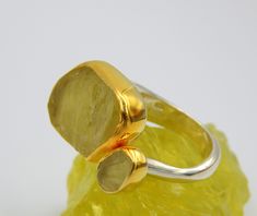 Rough Lemon Quartz double stone big Statement Ring made out of Sterling Silver 18 karat gold plated. 100% handmade one of a kind Jewellery. LEMON QUARTZ: Lemon quartz crystal is uplifting, cleansing and sunny. It is a stone of abundance much like citrine. Whereas citrine is golden or orange in colour, lemon quartz has a fresh yellow hue with green undertones. It comes in palest, clear lemon to a very vibrant yellow. Sometimes referred to as lemon citrine or yellow topaz in jewelry. Occurs natura Gold Rings With Large Stone For Anniversary, Gold Topaz Ring With Large Stone As Gift, Gold Sterling Silver Rings With Large Stone, Yellow Gold Rings With Large Stone For Anniversary, Yellow Gold Ring With Large Stone For Anniversary, Double Stone Ring, Rough Gemstone Ring, Lemon Quartz Ring, Big Statement Rings