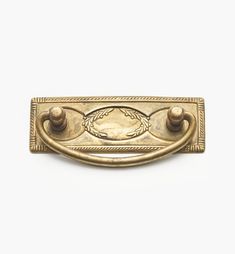 an antique brass door handle with two knobs on each side and a roped design