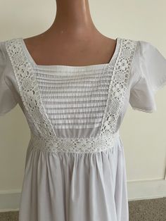 Original 1970s Laura Ashley white cotton Baby Doll/Prarie-style maxi dress. A rare and unique garment. We've only been able to find one other 1970s-era Laura Ashley dress for sale in Australia and it is upward of $550.  Purchased new from the Laura Ashley store in Melbourne in the 1970s. Design features: Baby doll Square neck with lace trim Features: pin tucked bodice with 2cm wide lace detail, long, gathered, 4 gore skirt with 3cm pleats at hem, square neck and square back, lace edged butterfly sleeves, back opening with 4 buttons* In perfect condition, other than one original button is missing and has been replaced (*see last photo) Skirt has an 11cm hem that can be let down to make it longer 65% polyester,  35% cotton Size 10 Measurements: Underam to underarm: 44cm Shoulder to under bus Rose Blood, Gore Skirt, Ashley White, 1970s Design, Gored Skirt, Laura Ashley Dress, Butterfly Sleeves, 60s Fashion, Style Maxi Dress