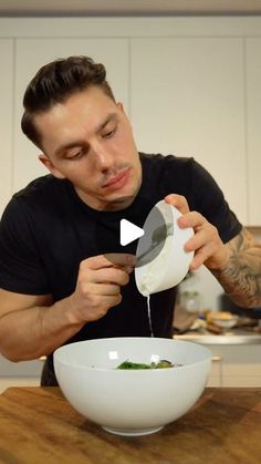 a man is pouring something into a bowl