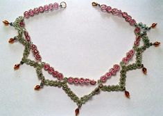 This is a double-strand hand-stitched crystal and glass bead necklace. It is comprised of pink and green Swarovski crystals ringed with glass seed beads and glass bead dangles. The necklace is strung on FireLine thread.19" including clasp Handmade Pink Crystal Beaded Necklaces, Pink Beaded Necklaces With Round Beads And Bead Caps, Pink Beaded Necklaces With Bead Caps, Pink Crystal Beaded Necklaces, Pink Crystal Beaded Necklaces For Jewelry Making, Pink Crystal Beaded Necklace For Jewelry Making, Pink Bohemian Crystal Jewelry, Bohemian Pink Crystal Jewelry, Bead Dangles