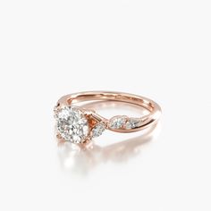 a rose gold engagement ring with two pear shaped diamonds