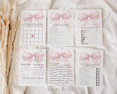 the wedding stationery is laid out on a bed