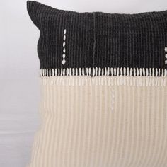 a black and white striped pillow sitting on top of a table