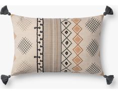 an embroidered pillow with tassels on the front and back, in beige tones