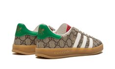 The Gucci x adidas Gazelle “Beige” is a limited edition collaboration by the legendary high fashion house on the popular lifestyle sneaker that features the brand’s iconic monogram pattern.  Gucci and adidas’s second collaboration brings a luxurious twist to the adidas Gazelle by placing the former’s “GG” monogram print in an all-over style on the shoe’s canvas upper.  The look is inspired by 1980s-era sportswear aesthetics.  Black leather Three Stripes branding can be found on either side of th Adidas Gazelle Beige, Adidas Gucci Gazelle, Gucci X Adidas, Stripes Branding, Cheetah Print Shoes, Adidas Gucci, Sneakers Outfit Men, Nike X Travis Scott, Toddler Adidas