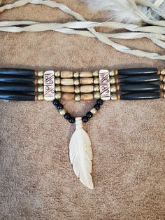 "Native American Indian Style Choker - Black Buffalo Horn and Antique Bone Hairpipe Native American Indian style Choker with tie in back. Includes brass and bone accent beads. Order without pendent, with 3 1/2\" antique bone feather pendant, or 2.5\" deer antler horn tip. All items are handmade by me in the United States. Because this is made from natural products, each one will vary slightly in color. You can also order a Genuine Horn and Bone hairpipe bead choker in the following colors (see m Native American Jewelry Diy, Raven Mocker, Native Accessories, Native American Style Outfits, Native Indian Jewelry, Deer Antler Jewelry, Native American Feathers, Native Beading Patterns, Native American Clothing