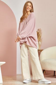 This blouse is out to prove that comfy and chic can coexist in perfect harmony. Its flowy, dolman cut gives you room to breathe while still maintaining a flattering drape. 3/4 sleeves keep it seasonal, transitioning effortlessly from summer to fall. A plunging V-neckline shows just enough skin to be subtly seductive, but the blush pink hue is as sweet and charming as an English rose garden. In short, this top lets you make a stylish statement without having to sacrifice one ounce of comfort. It’ Chic Oversized Long Sleeve Blouse, Chic Slouchy Tops For Spring, Flowy Blouse For Spring Loungewear, Oversized Lantern Sleeve Blouse For Spring, Oversized Blouse For Day Out, Chic Blouse For Casual Gatherings, Oversized Versatile V-neck Blouse, Versatile Oversized V-neck Blouse, Chic Oversized Solid Color Blouse