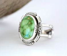 Bold, chunky yet dainty Verde Turquoise Silver ring for her. The setting is an oval cabochon 14mm x 9mm that is in a Bezel setting. This boho artisan ring has been handmade using 925 Sterling Silver that has been fused, stamped and lightly oxidized then polished. The tapered band is 5/16" then narrows to 1/8" and cannot be resized. Size 5 1/2 The vibrant green turquoise stone perfectly complements the silver detailing, creating a unique bohemian piece that will undoubtedly turn heads. Whether yo Unique Green Turquoise Ring With Polished Finish, Unique Green Polished Turquoise Ring, Green Rings With Large Oval Cabochon Stone, Green Oval Turquoise Gemstone Ring, Green Oval Cabochon Ring With Large Stone, Bohemian Green Oval Cabochon Ring, Green Turquoise Ring With Polished Finish, Green Polished Turquoise Ring, Green Oval Ring With Large Stone