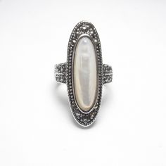 Sterling Silver 3.00 Ct Oval Mother Of Pearl And Marcasite Ring Vintage Vintage Silver Opal Ring With Oval Shape, Vintage Silver Oval Opal Ring, Vintage Silver Oval Pearl Ring, Antique White Oval Moonstone Ring, Formal Oval Mother Of Pearl Rings, Antique Silver Oval Pearl Ring, Silver Oval Mother Of Pearl Rings, Silver Oval Rings With Mother Of Pearl, Vintage White Oval Pearl Ring