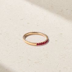 Loved for its barely there, stackable design and versatility, our Thread Ring is the most perfect choice for the modern woman. Brilliant rubies are hand set in elegantly sculpted prongs that extend three quarters around the finger. For the minimalist, we love it as an everyday essential that can be worn on its own for an elegant and understated appearance. For those who fancy a more elaborate look, stack together multiples for a more significant statement. It can also serve as a beautiful companion to your engagement ring. Metal: 18kt Gold Ruby Weight: 0.50 ct. Measurements: 1.5 mm length *Please note that the listed ct. weights are approximate and may be subject to slight variations. Minimalist 14k Gold Eternity Band With Vvs Clarity, Luxury Stackable Ruby Ring With Round Band, Modern Stackable Rings For Promise, Luxury 14k Gold Stackable Ruby Ring, Elegant Stackable Yellow Gold Ruby Ring, Ruby Eternity Band In Yellow Gold Stackable, Stackable Ruby Eternity Band In Yellow Gold, Yellow Gold Ruby Eternity Band Stackable, Elegant Stackable Ruby Ring In Yellow Gold