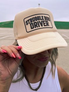 Hop aboard the Struggle Bus and rock this tan trucker hat! Perfect for anyone who knows the struggle of being a regular human, with an adjustable snap back for the perfect fit. Don't miss your chance to join the fun and funky Struggle Bus crew. One Size Fits Most Trucker Style Adjustable Snapback Tan Color Struggle Bus Driver Graphic Color May Vary From Different Viewing Device *This item is a final sale item! No returns or exchanges will be allowed on this item* Funny Adjustable Trucker Baseball Cap, Funny Adjustable Trucker Hat For Streetwear, Funny Adjustable Trucker Hat, Struggle Bus, Cap Girl, Maxi Romper, Shoe Boot Sandals, Bus Driver, Snap Back