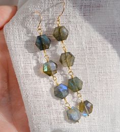 Feeling a bit fancy? These long and lavish Azora Earrings feature hexagonal labradorite that will have you glowing in no time. Handcrafted with three natural, faceted gemstones that change color with every move, these crystal dangles are perfect for those times when you need a little change in your life. Available in 14k gold filled or sterling silver, they also come with secure silicone backings. Stone Size: average 9mm (.35") Faceted Labradorite Beads For Crafting, Labradorite Jewelry With Faceted Beads As A Gift, Labradorite Jewelry With Faceted Beads For Gift, Faceted Labradorite Dangle Jewelry, Labradorite Earrings, Crystal Dangle Earrings, Labradorite Crystal, Sterling Silver Jewelry Handmade, Faceted Gemstones