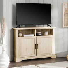 a flat screen tv sitting on top of a wooden cabinet