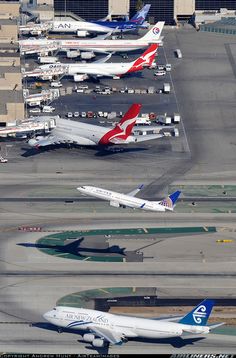 several airplanes are parked on the tarmac at an airport, including one for australia