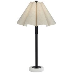 a black and white floor lamp with a beige shade