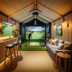 a living room filled with furniture and a golf simulator