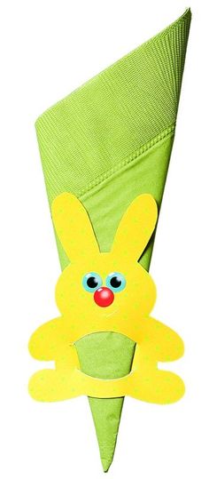 a green paper cone with a yellow bunny on it's face and eyes, sitting in front of a white background