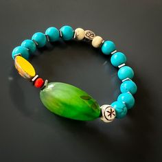 The Green Agate Summer Vibe Bracelet is a stunning accessory that exudes a sense of energy and vitality. The Green Agate stone is said to promote balance and harmony, while the other stones and beads are thought to have their own unique energy properties as well.The bracelet also features a vibrant yellow African bead, which is said to symbolize happiness and prosperity. Together, these elements create a beautiful and vibrant piece that is perfect for adding a touch of color to any summer outfit Jade Bracelets With Natural Stones For Meditation, Spiritual Healing Bracelets With Oval Beads, Handmade Jade Beaded Bracelets For Healing, Bohemian Blue Agate Bracelets, Handmade Jade Bracelets For Meditation, Spiritual Agate Beaded Bracelet With Polished Beads, Spiritual Agate Beaded Bracelets With Polished Beads, Agate Bracelets With Polished Beads For Meditation, Bohemian Agate Beaded Bracelets For Meditation