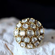 a gold ring sitting on top of a rock