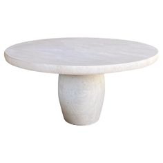 a white marble table with a circular base on it's end, against a white background