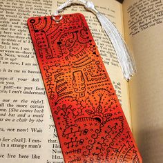 an orange bookmark with intricate designs on it