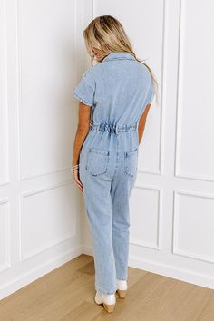 Jump into trendy style with this denim jumpsuit! Unlined denim material - A collared v-cut neckline that goes into a button-up bodice - Short sleeves - A functional chest pocket - A waistline with an elastic back, belt loops, a hidden zip fly, and button closure - Functional side and back pockets - A relaxed silhouette that ends in ankle length hemlines Spring Medium Wash Denim Jumpsuits And Rompers, Trendy Light Wash Overall Jumpsuits, Trendy Light Wash Denim Overall Jumpsuit, Medium Wash Denim Jumpsuits And Rompers, Denim Jumpsuits And Rompers In Medium Wash, Trendy Light Wash Denim Overalls, Light Wash Denim Jumpsuit With Button Closure, Casual Light Wash Denim Jumpsuit, Casual Light Wash Denim Jumpsuit With Button Closure