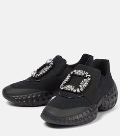 For a glamorous take on athleisure, look to Roger Vivier’s Viv’ Run Moonlight sneakers. They're made from black, sock-like technical uppers with thick rubber soles, and have grosgrain-backed embellished buckles..Sole: leather insole, rubber sole.Toe shape: round toe.Lining: fabric.Comes with a box.Made in Italy.Designer color name: Nero.Comes with dust bag.Upper: fabric.Trim: crystal.Closure: elasticated strap.Fits slightly large to size - we recommend trying a half size smaller.Stretchy fabric. Modern Black Chunky Sneakers With Studded Outsoles, Black Sporty Slip-on Sneakers With Studded Outsoles, Slip-on Low-top Sneakers With Lug Sole, Black High-top Textile Slip-on Sneakers, Black Slip-on Sneakers With Abzorb Midsole For Athleisure, Black Slip-on Sneakers With Lug Sole, Vivier Shoes, Roger Vivier Shoes, Roger Vivier